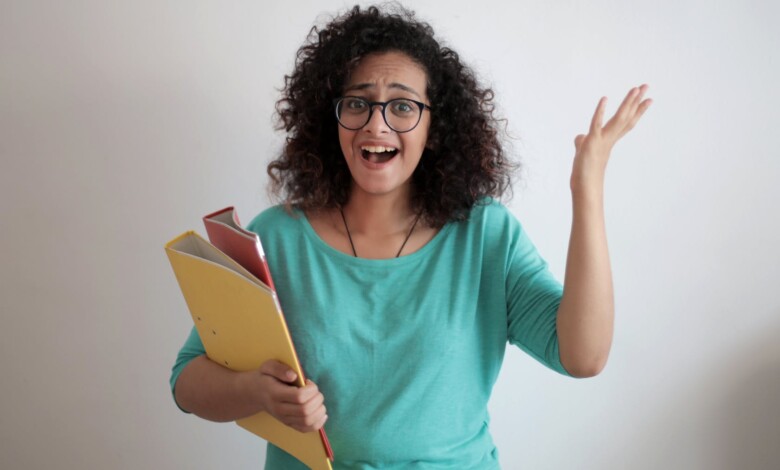 adult displeased businesswoman with papers in light modern office