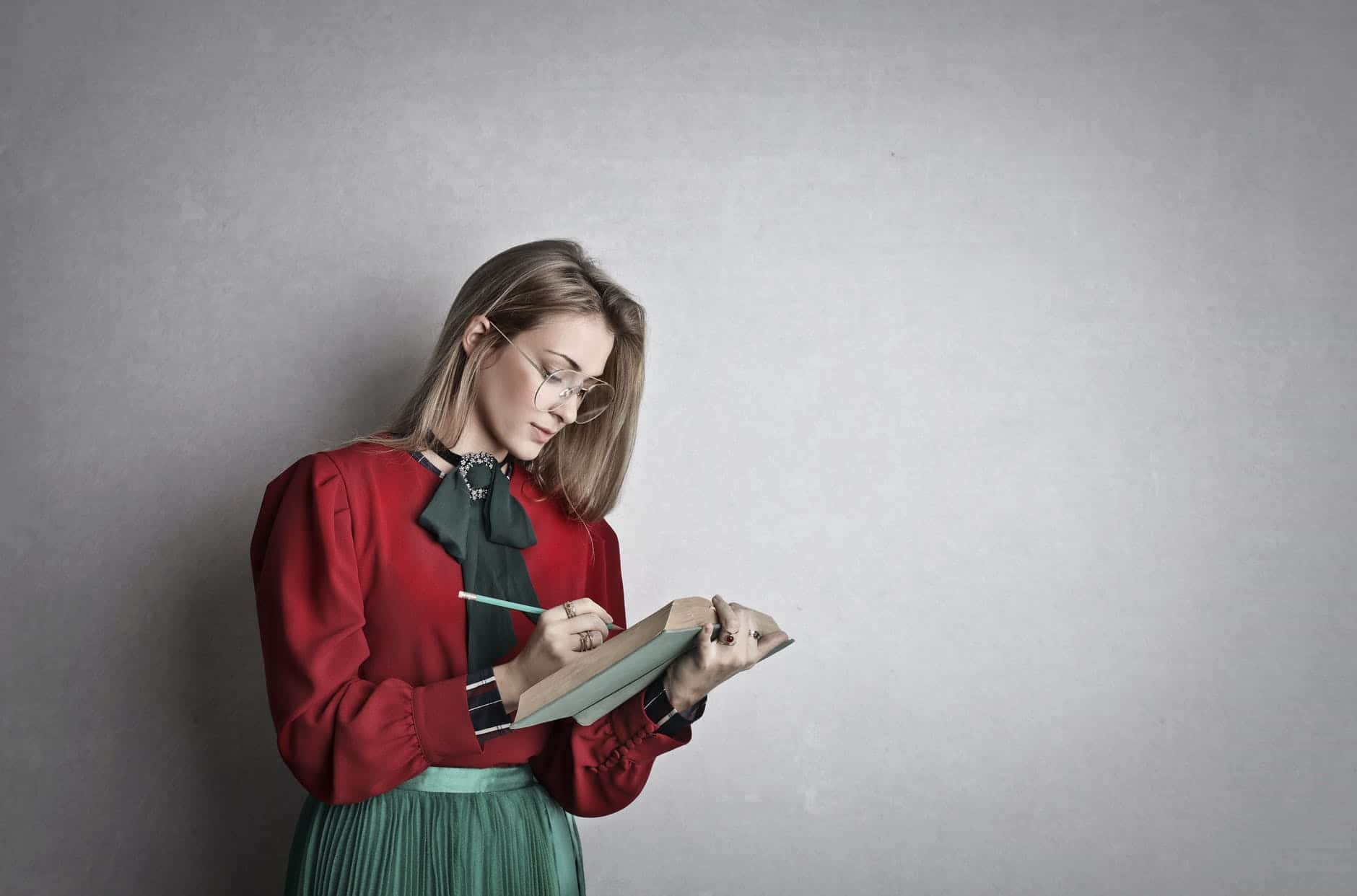 smart adult female student reading book in studio