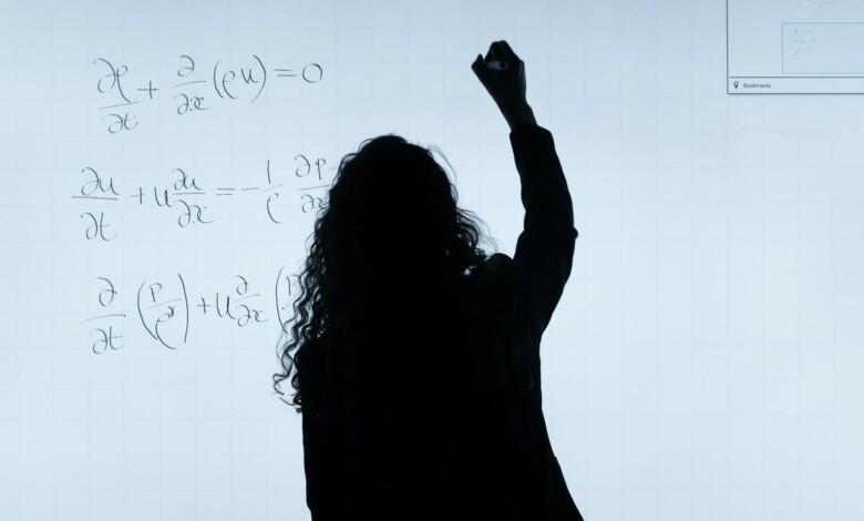 woman writing on a whiteboard