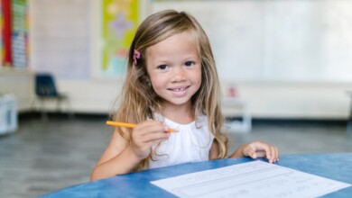 blonde girl holding a pencil