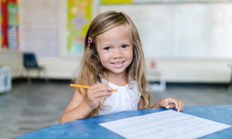 blonde girl holding a pencil