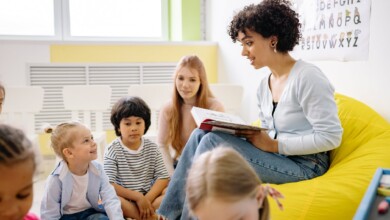 woman reading a book to the children
