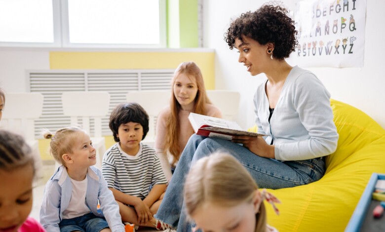 woman reading a book to the children