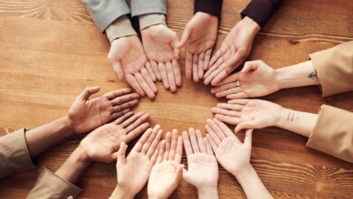 photo of people s hand on top of wooden table