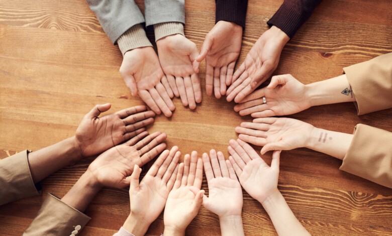 photo of people s hand on top of wooden table