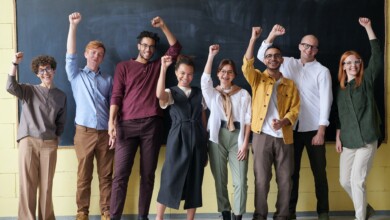 group of people standing infront of blackboard