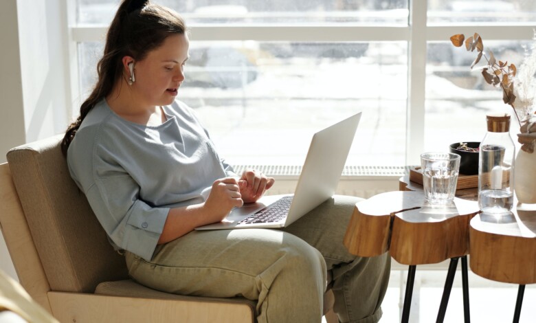girl sitting on a couch using a laptop