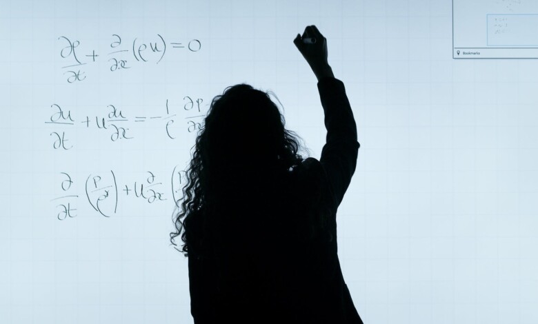 woman writing on a whiteboard