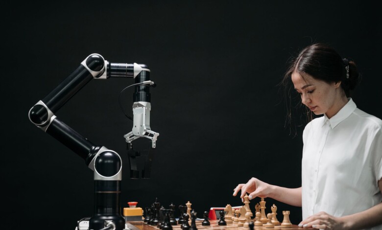 woman in white shirt playing chess against a robot
