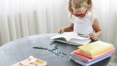 focused girl reading book at home