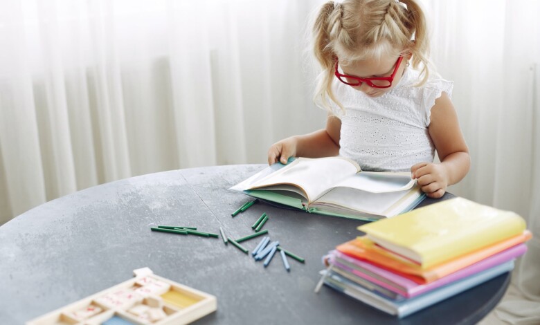 focused girl reading book at home