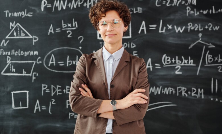 photo of woman standing in front of blackboard