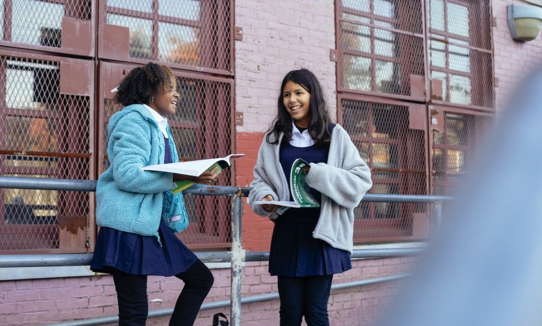 happy smiling diverse girls discussing lessons after school