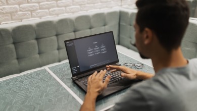 a man is sitting at a table with a laptop