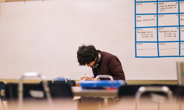 man writing on table