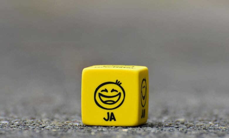 yellow cube on brown pavement