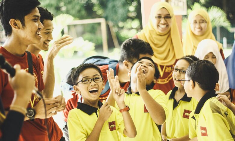 laughing children in between woman and man at daytime