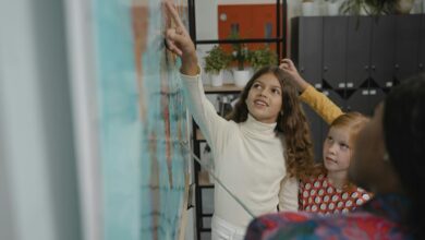 attentive student pointing on a map