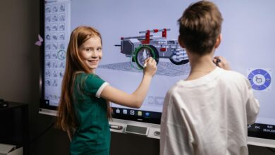 two kids standing by an interactive board
