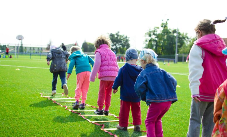 children s team building on green grassland