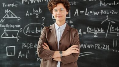 photo of woman standing in front of blackboard