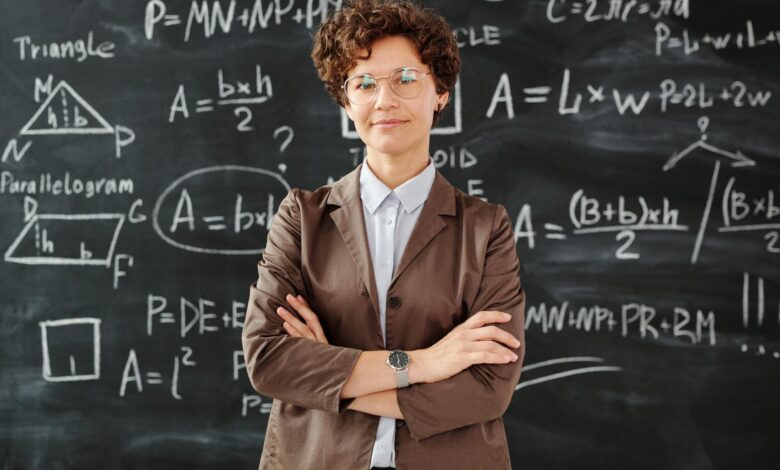 photo of woman standing in front of blackboard