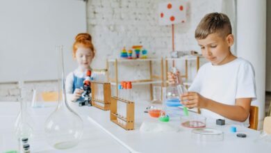 a boy and girl doing experiment in the laboratory