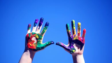 person s hands with paint