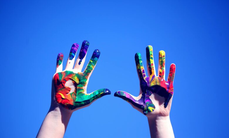 person s hands with paint