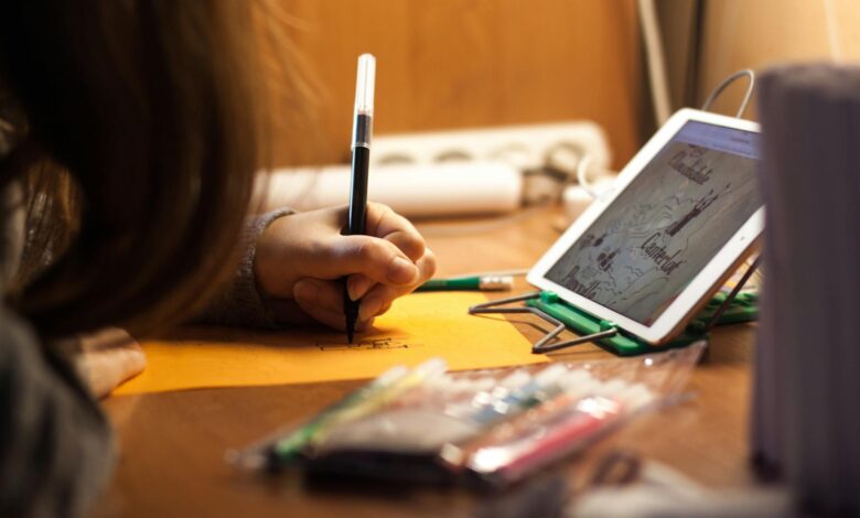 woman writing on orange paper