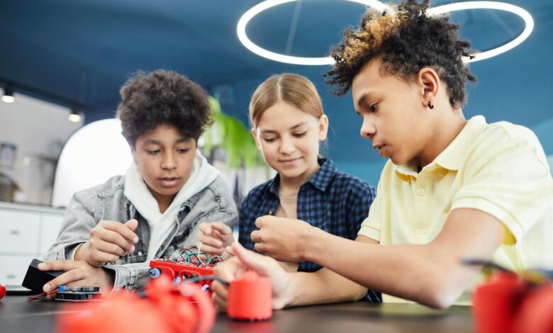young students doing robotics together
