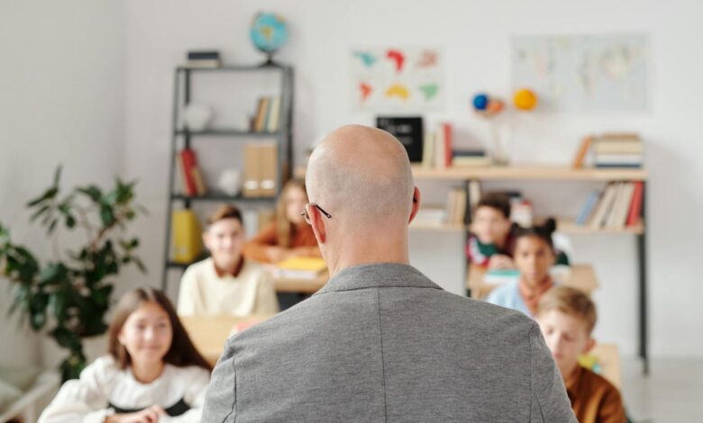 man in a gray shirt in front of the students