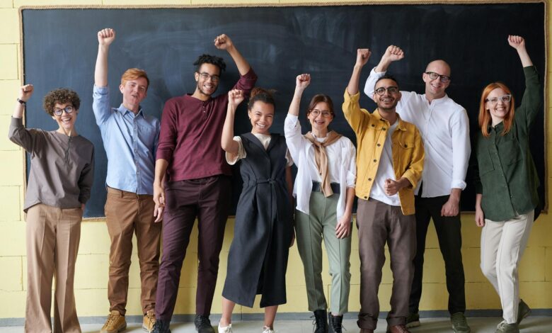 group of people standing infront of blackboard