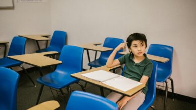 boy sitting on his desk looking lonely