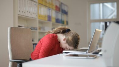 woman sitting on chair while leaning on laptop