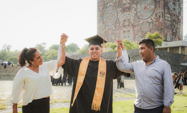 mother and father holding hands with graduate son