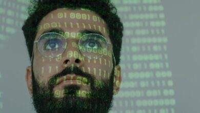 man with binary code projected on his face