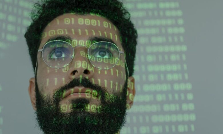 man with binary code projected on his face