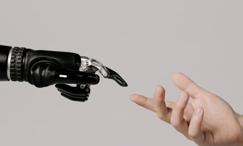 hand of a person and a bionic hand