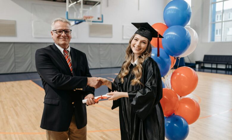 photo of happy woman in graduation gown
