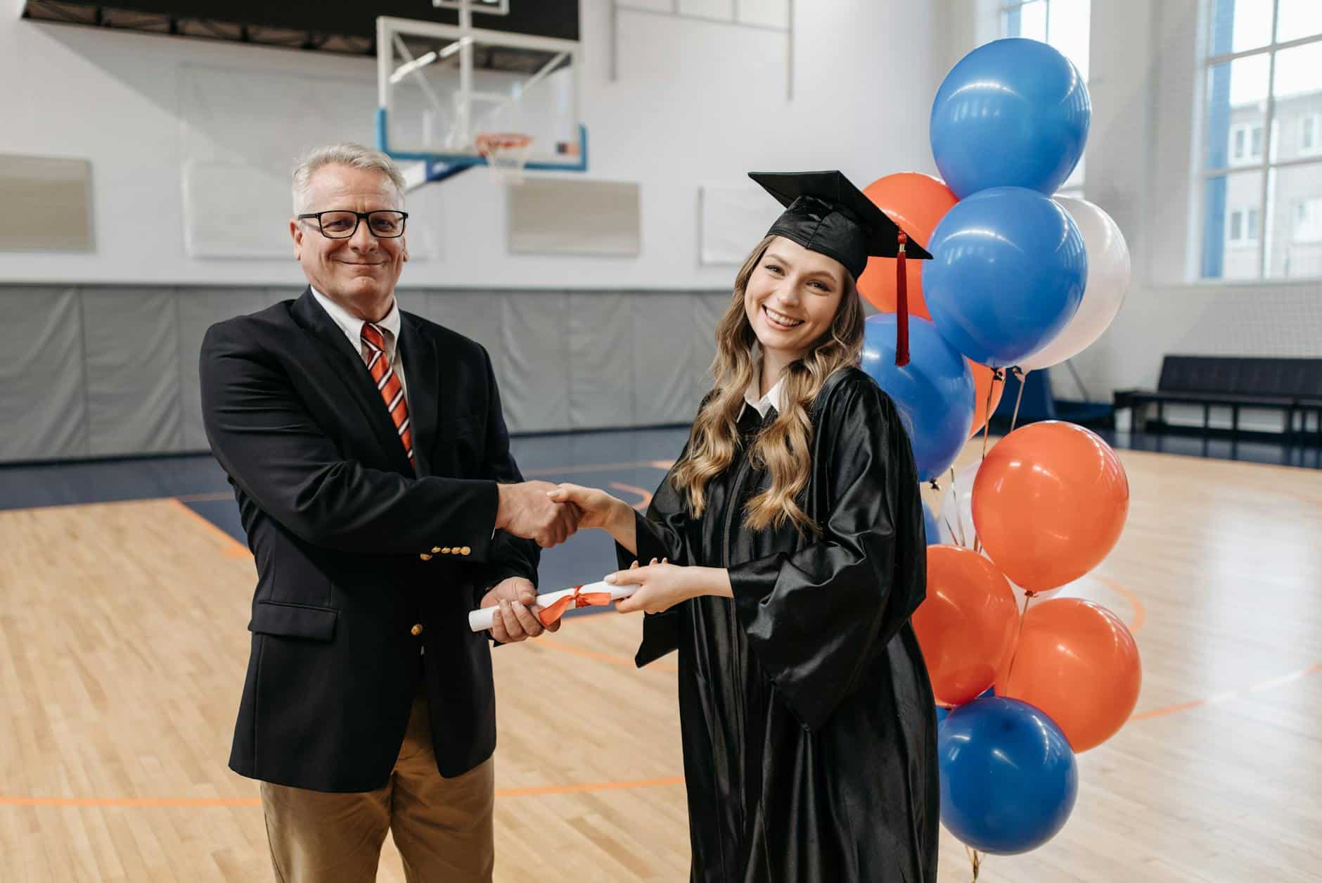 photo of happy woman in graduation gown