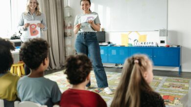 woman in white shirt standing in front of people