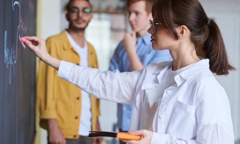 photo of woman writing on blackboard