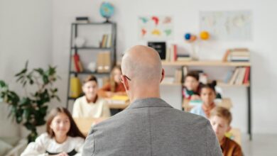 man in a gray shirt in front of the students