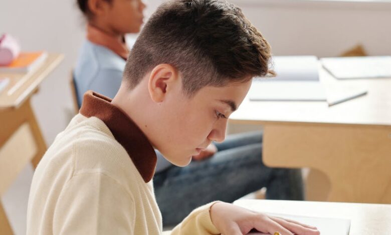 boy writing on his notebook