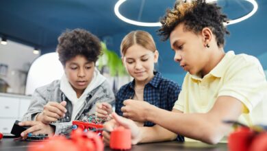 young students doing robotics together