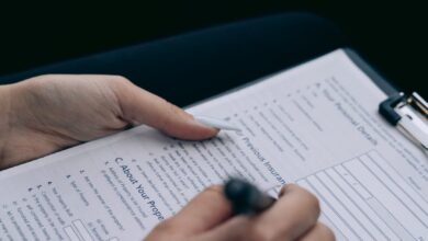 man signing documents