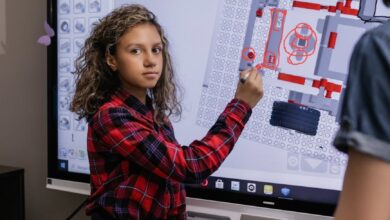 a girl standing by an interactive board