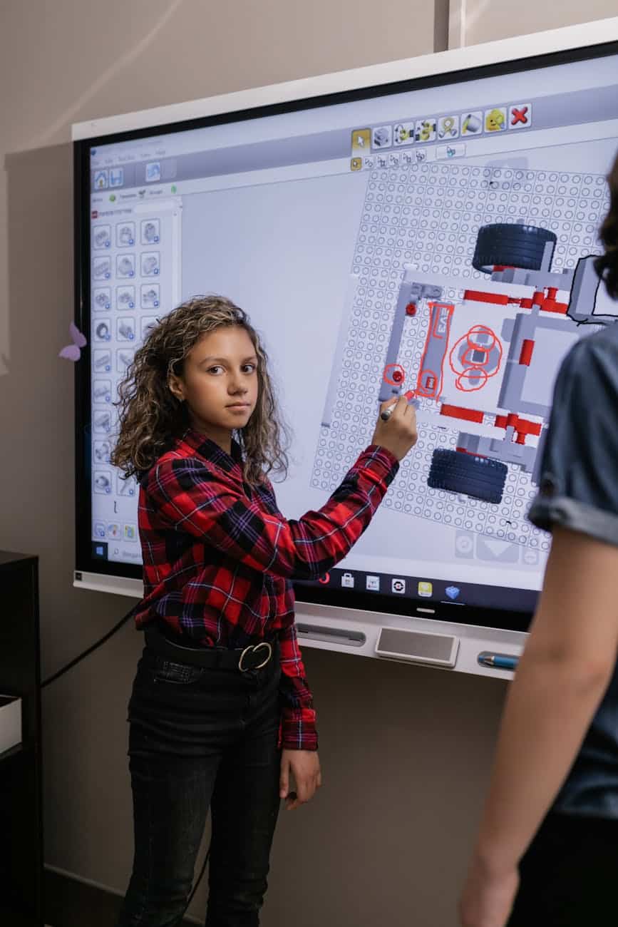 a girl standing by an interactive board