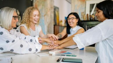 women putting their hands together